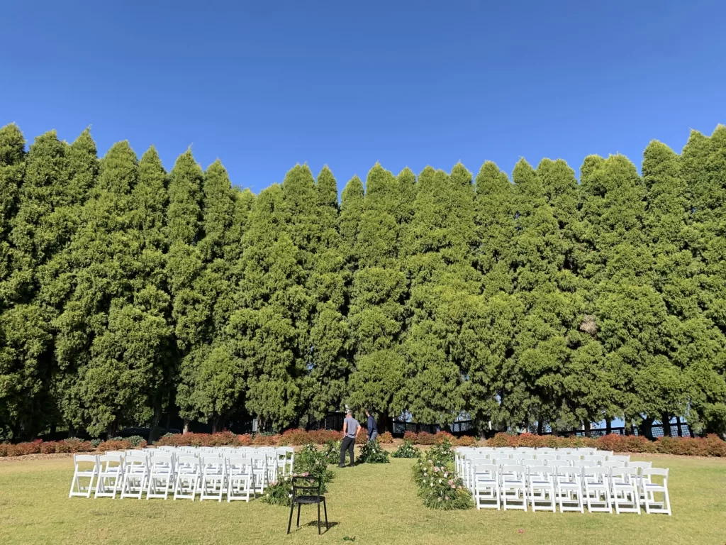 white padded folding chair at a wedding ceremony at the arc of pines