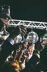people holding up wine glasses at a party