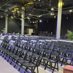 a mix of white and black padded folding chairs