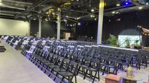 a mix of white and black padded folding chairs
