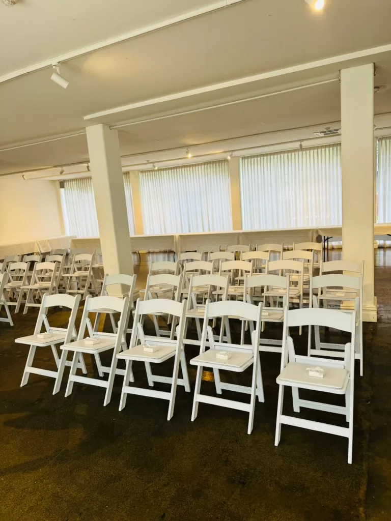 white padded folding chair at an event venue
