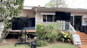 two tv with tv stands at a home backyard