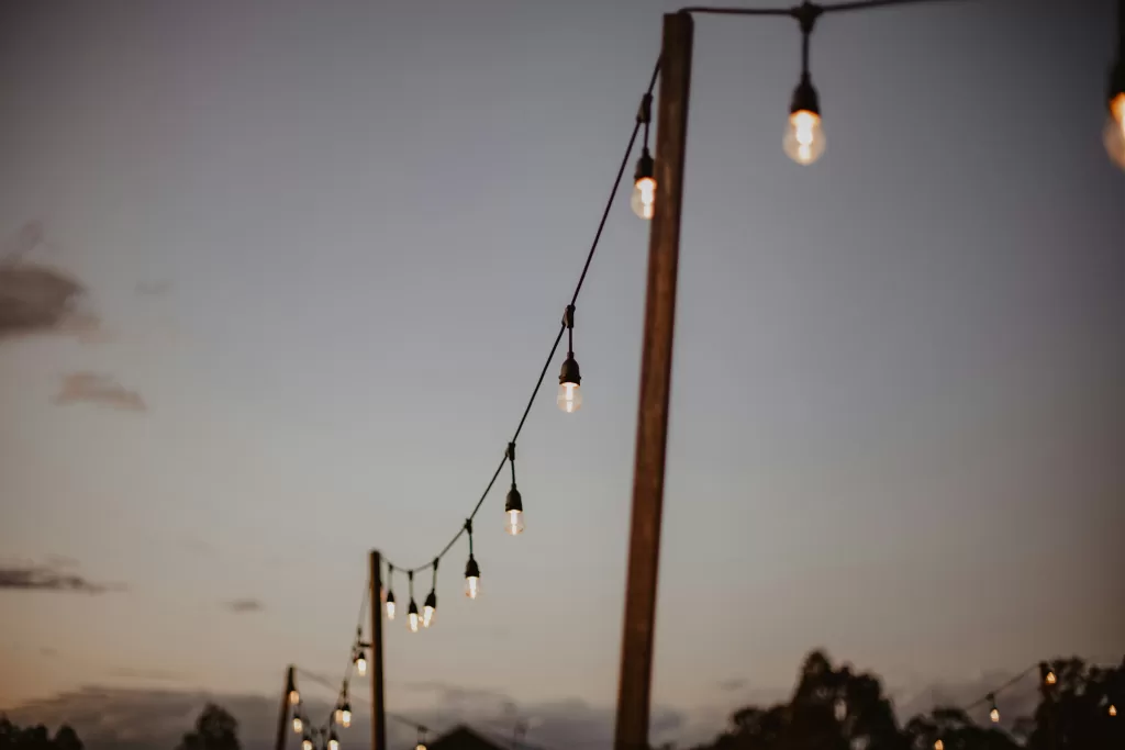 festoon lights hanging on wooden posts